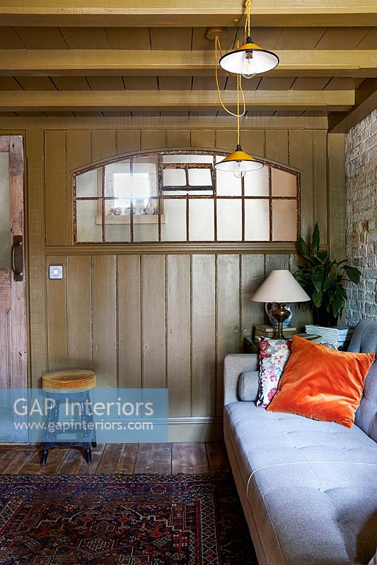 Brown painted wood panelling in country living room 