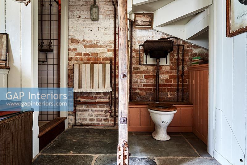 Wooden post and room divider in country bathroom 
