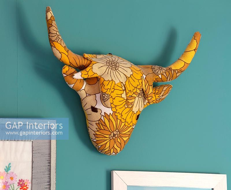 Fabric cow head on wall 