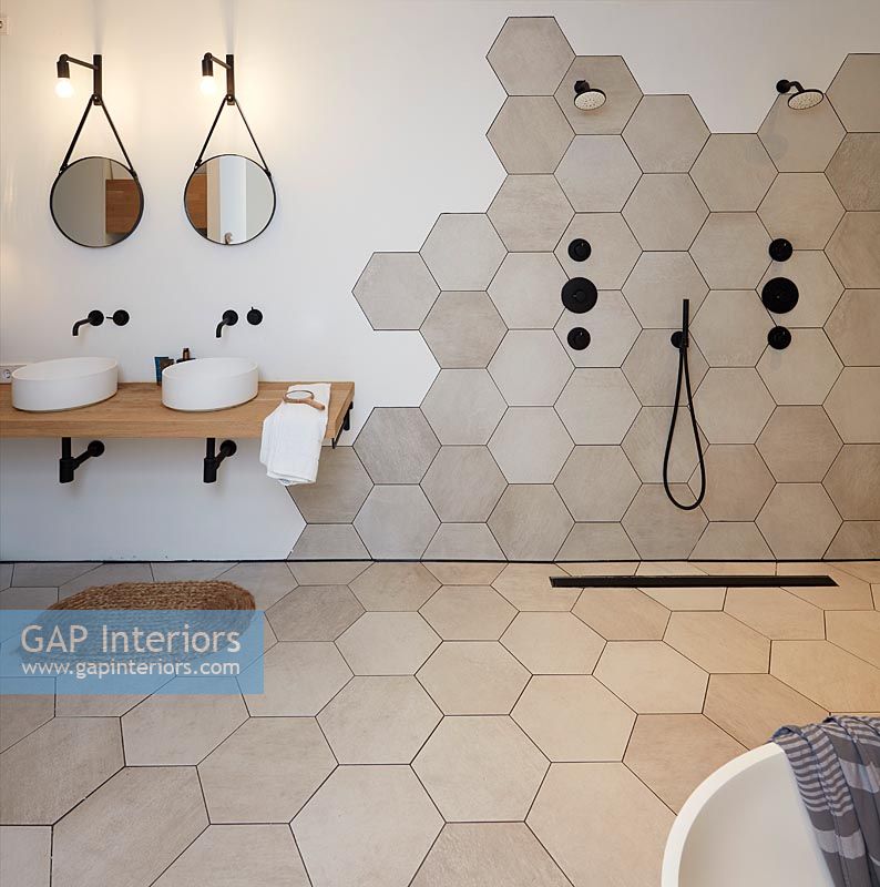 Modern bathroom with hexagonal tiling on floor and wall 