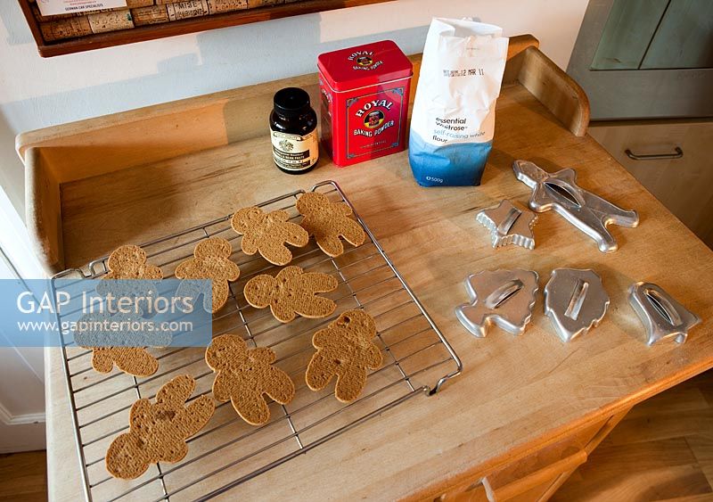 Gingerbread men on drying rack in kitchen 
