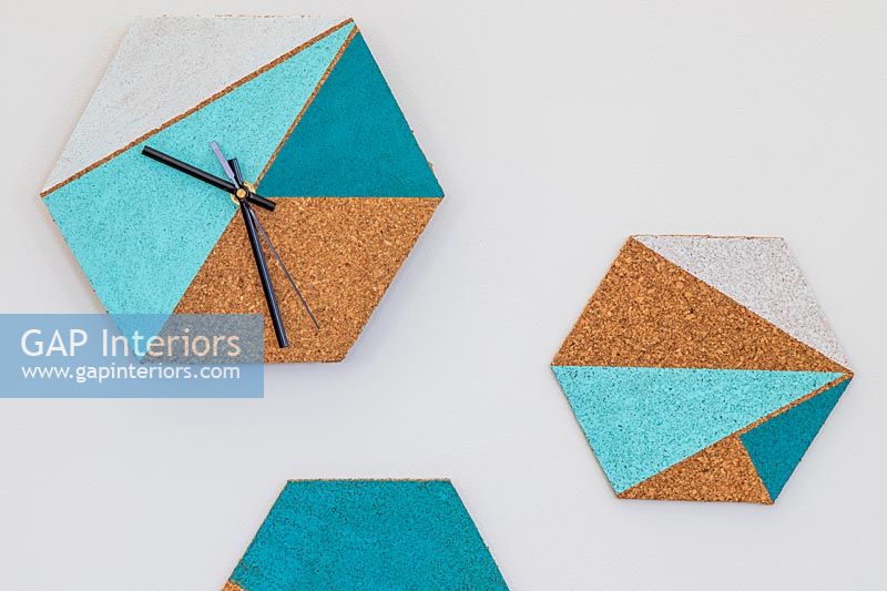 Wall clock made with hexagonal cork board and painted geometric areas