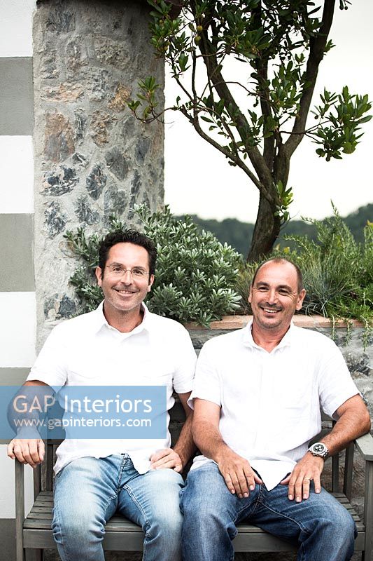 Garden designers Gianmarco Bernocchi (left) and Emilio Ravenna (right) sitting on balcony