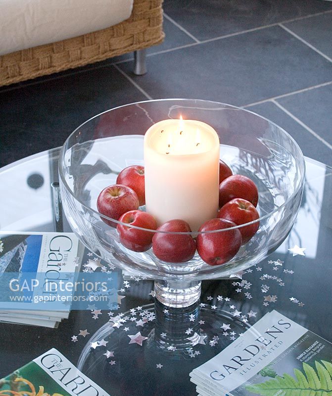Fruit bowl with apples and a candle
