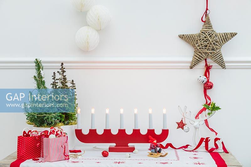 Table decorated for Christmas with wooden red advent candle light