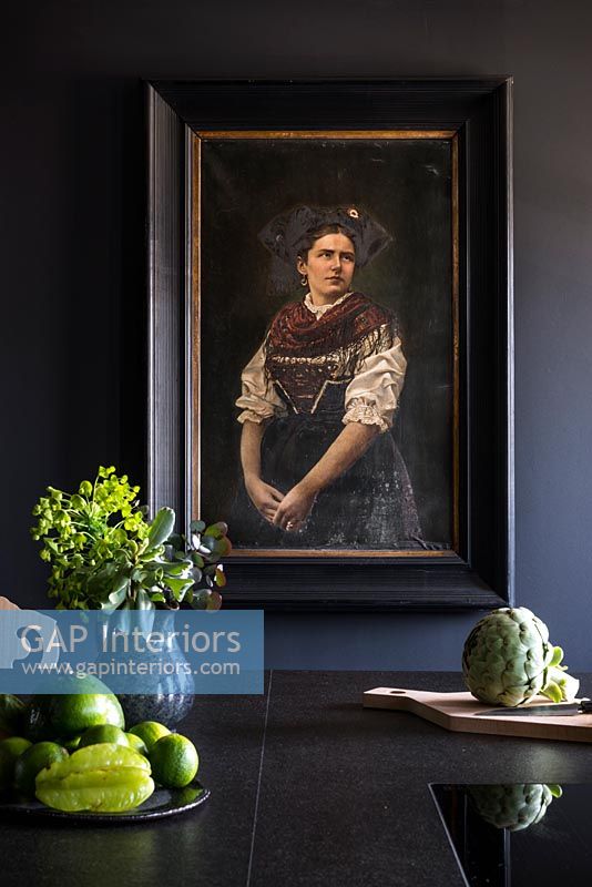 Classic portrait painting in kitchen 