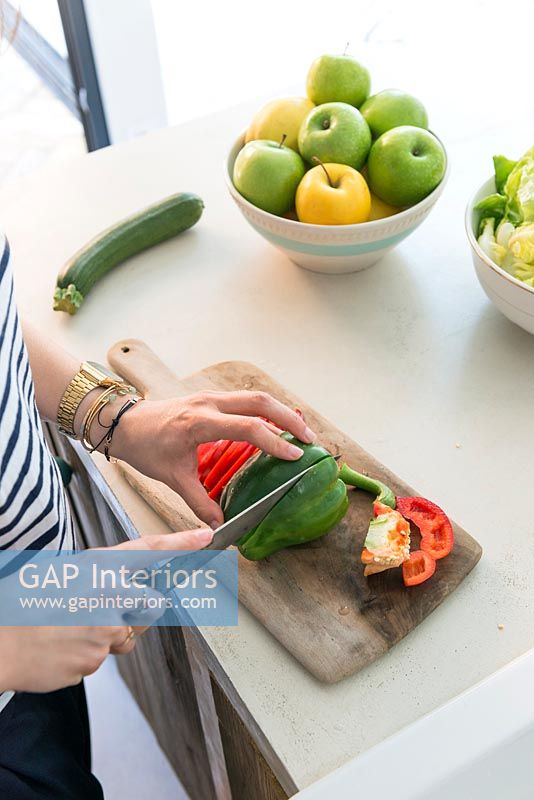 Woman cutting peppers 