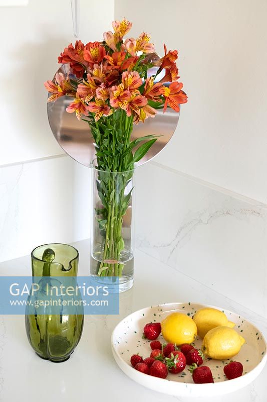Vase of flowers and fruit bowl 
