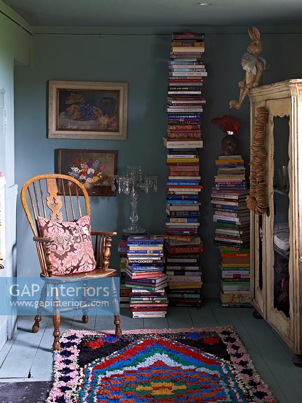 Piles of books next chair 