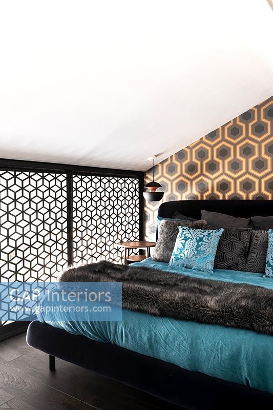 Small modern bedroom with patterned wallpaper 