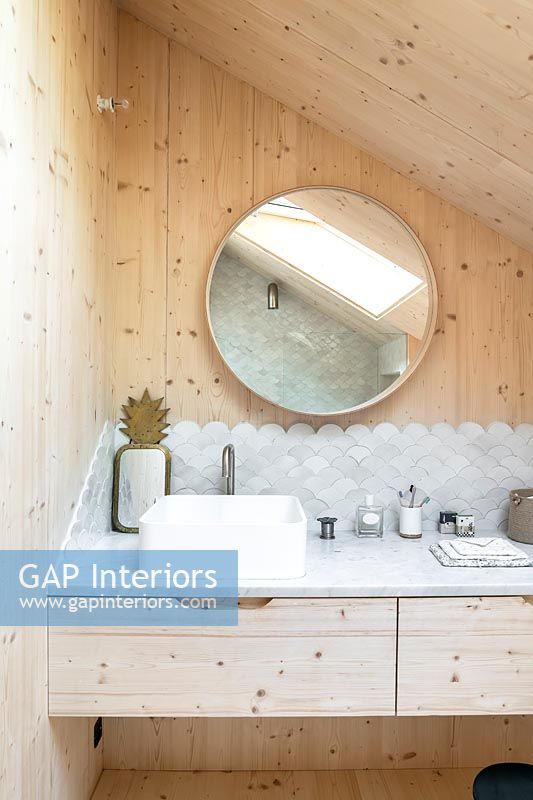 Modern wooden bathroom - sink with decorative tiling 