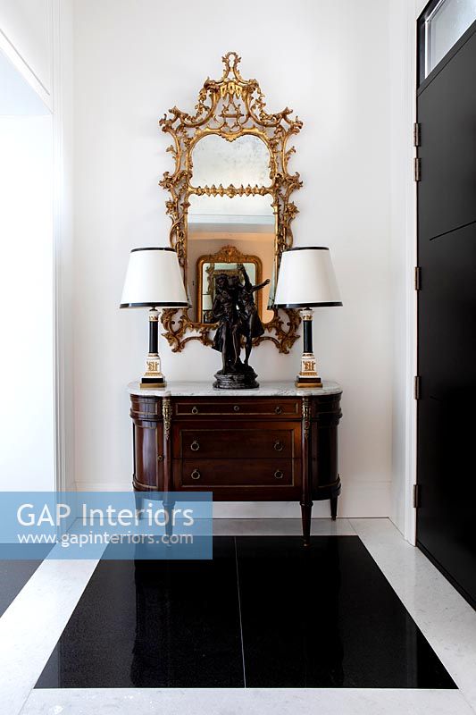 Classic cabinet in hallway with gilded mirror 