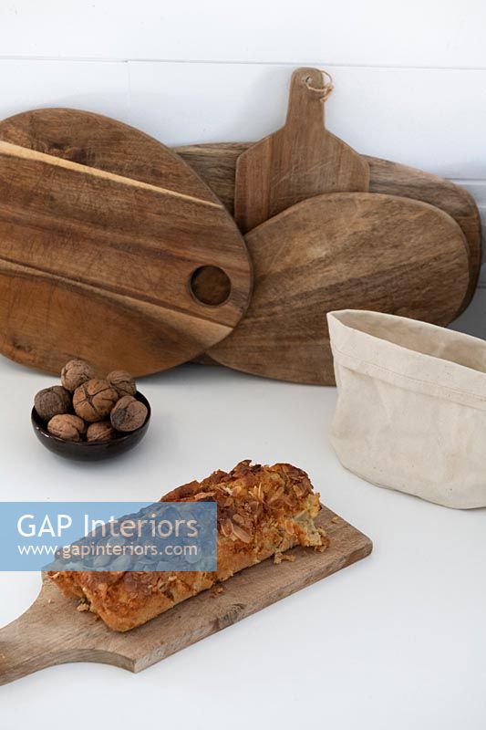 Wooden chopping boards and food on kitchen worktop