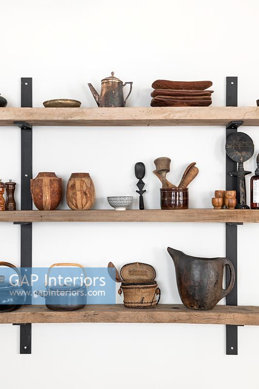 Wooden shelves with pots and kitchen utensils 
