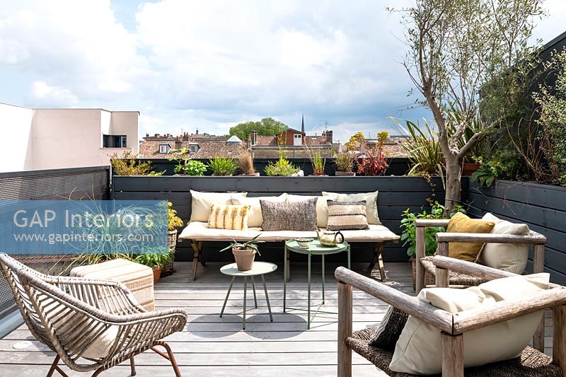 Seating area on decked modern roof terrace garden 
