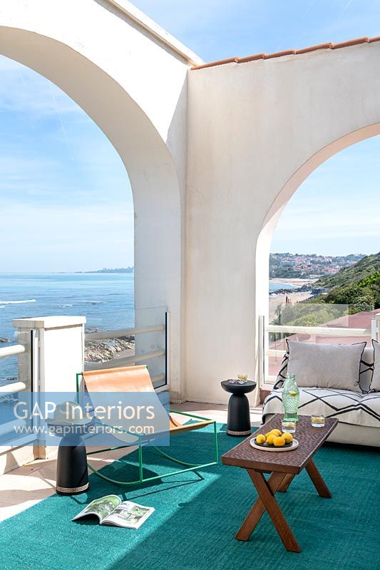Archways on furnished terrace with carpet and sea views 