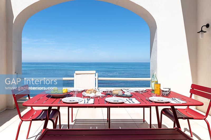 Outdoor dining area with sea views - table laid for lunch 