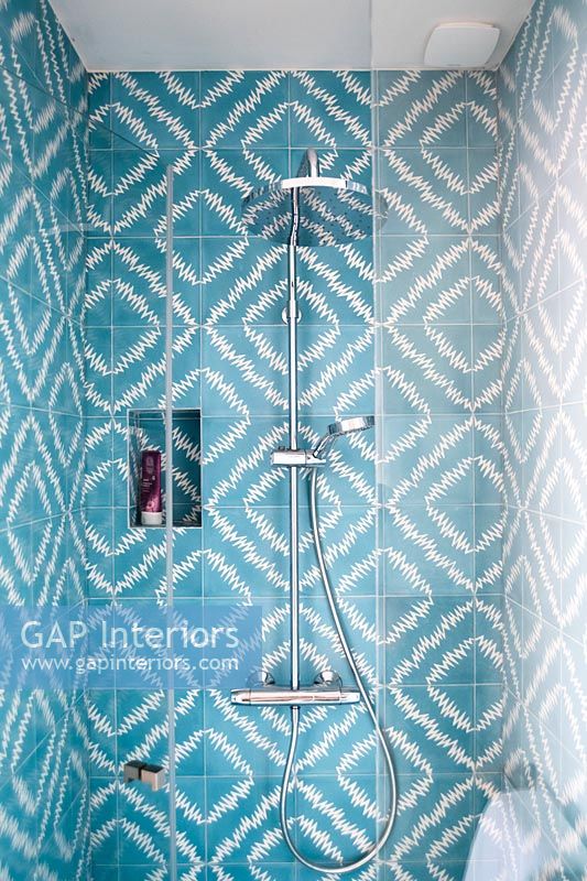 Blue and white patterned tiling in shower cubicle 