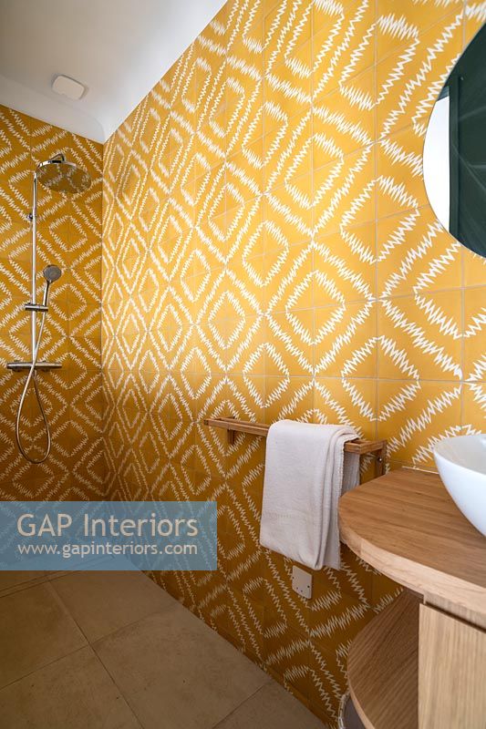 Yellow patterned tiling in modern shower room 