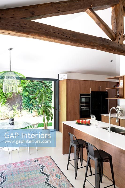 Modern kitchen-diner with exposed wooden beams 