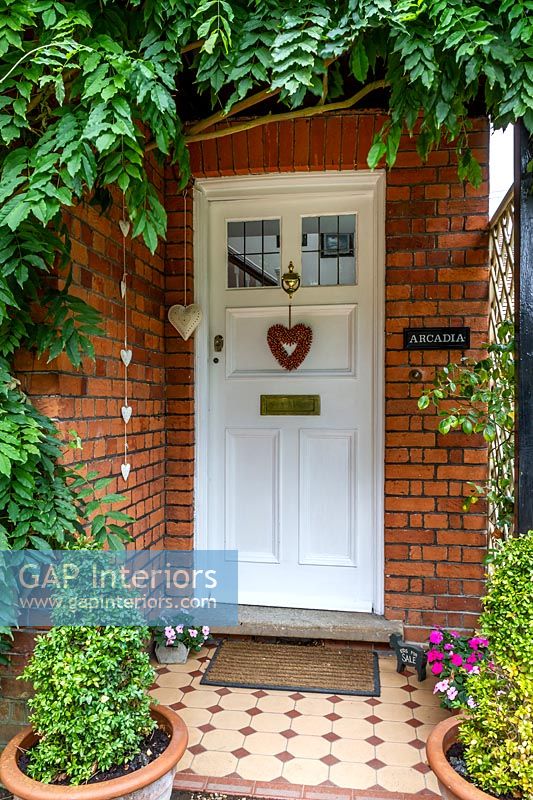 Exterior of classic house - front door with heart shaped wreath 