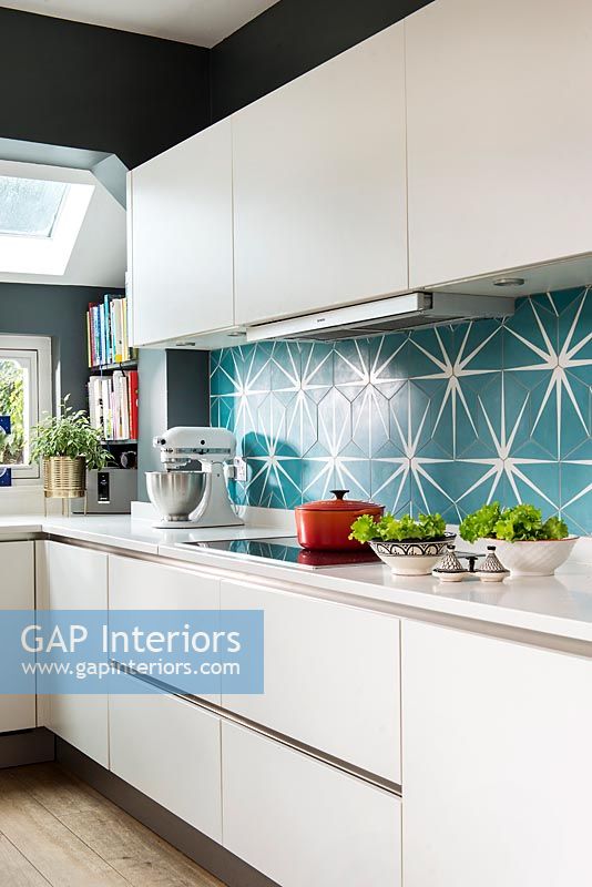 Teal and white patterned tiling in contemporary kitchen 
