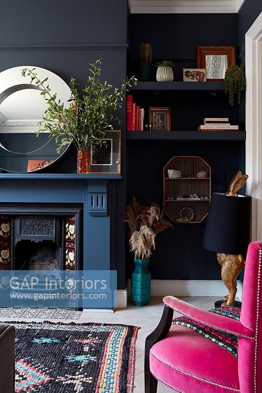 Modern living room with dark blue and black painted walls 