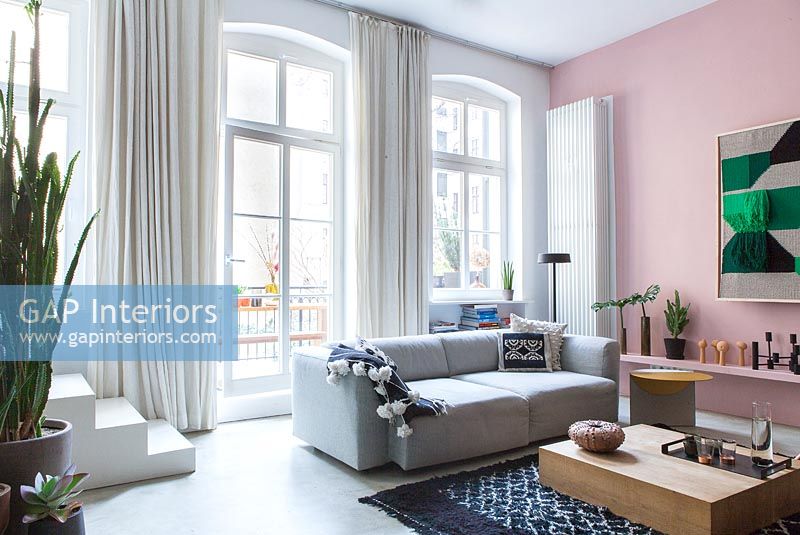 Modern living room with pink painted feature wall 