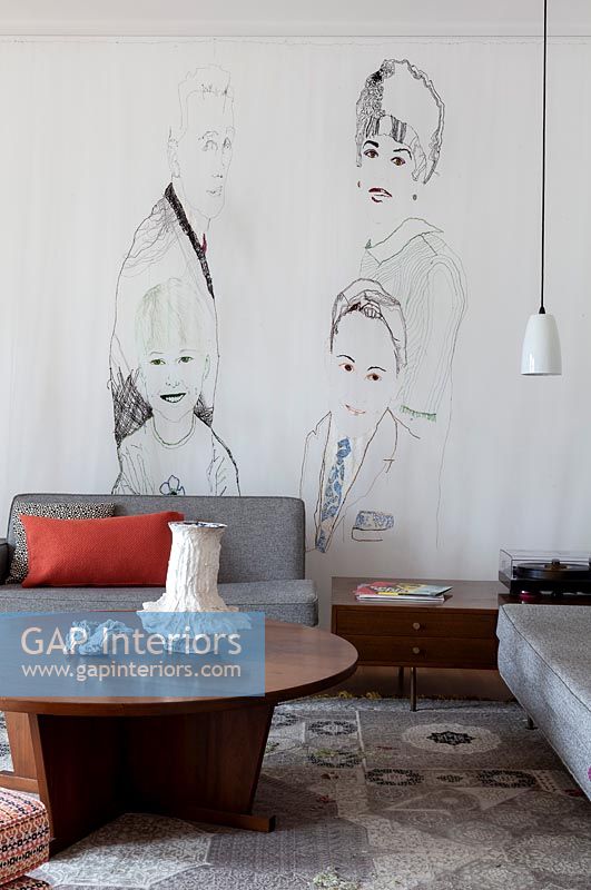 Modern living room with family portrait mural painted on wall
