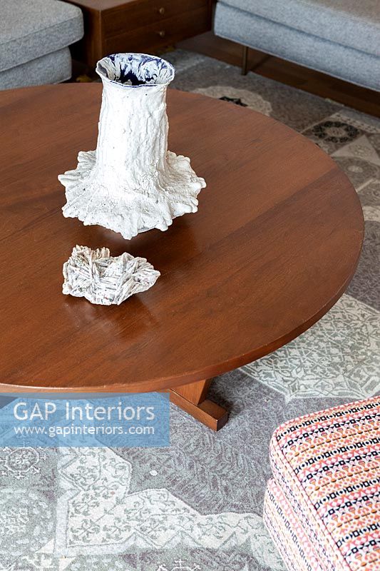 Sculptures on wooden coffee table 
