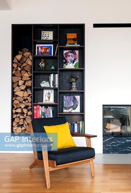 Modern living room with alcove shelving and firewood storage 