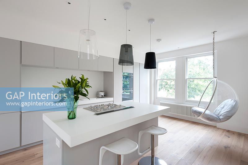 Contemporary kitchen with hanging egg chair 