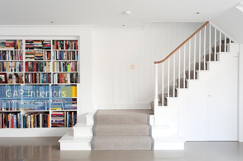 Large bookcase at the bottom of staircase 