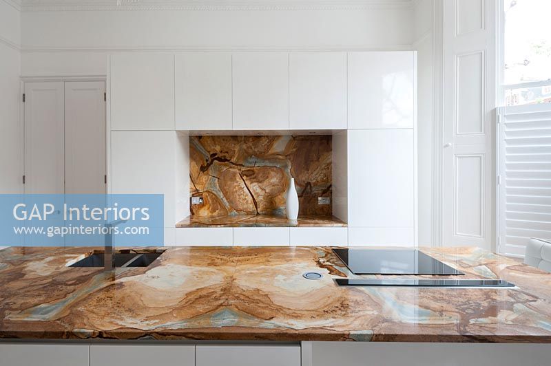 Decorative marble worktop and splashback in modern kitchen 
