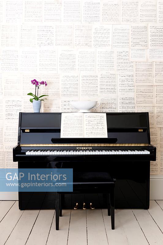 Piano with wall of sheet music 