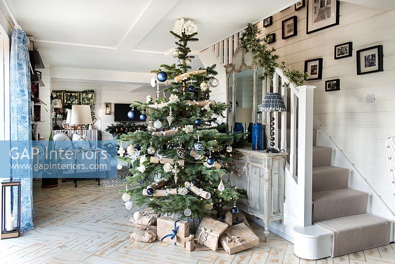 Large Christmas tree in modern country hallway 