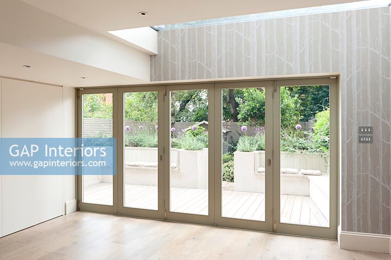 Contemporary bifold doors with view to courtyard garden 
