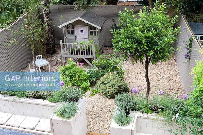 Painted wooden playhouse in courtyard garden - overhead view 