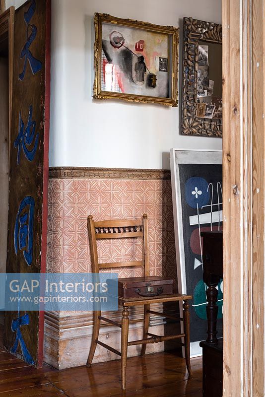 Vintage furniture and modern artwork in hallway