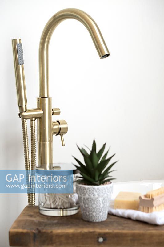 Gold mixer tap in modern bathroom 