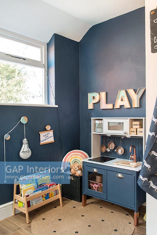 Play kitchen in dark blue painted childrens room 