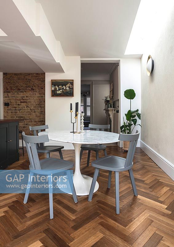 Parquet flooring and modern furniture in dining room 