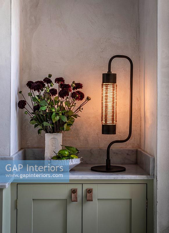 Modern lamp next to flower arrangement 