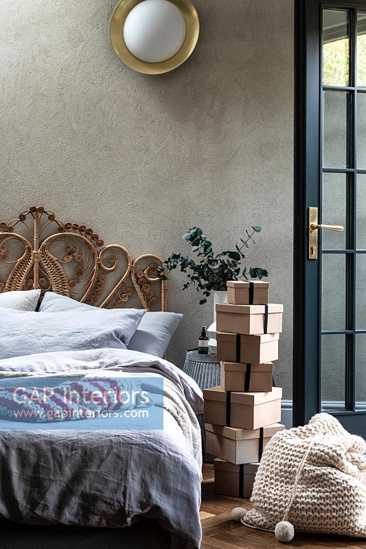 Large stack of gifts wrapped in brown boxes in modern bedroom 