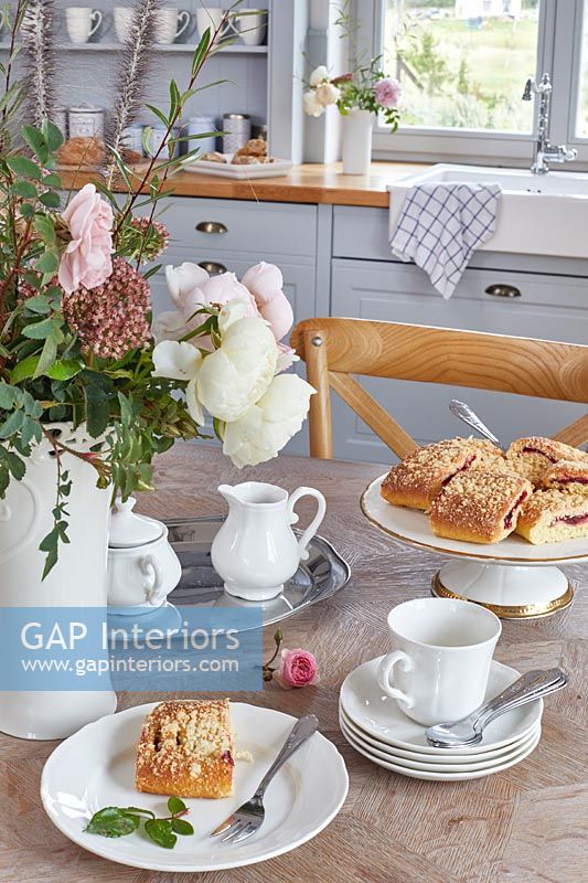 Tea and cakes on country kitchen table 