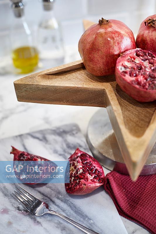 Pomegranates on wooden tray