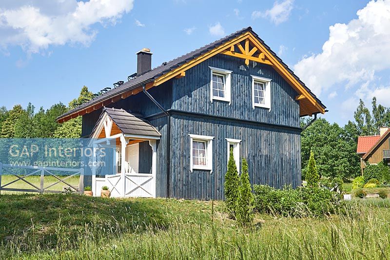 Exterior of blue wooden farmhouse 