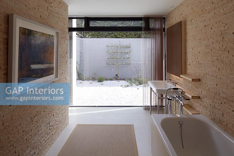 Contemporary bathroom with glazed wall at one end 