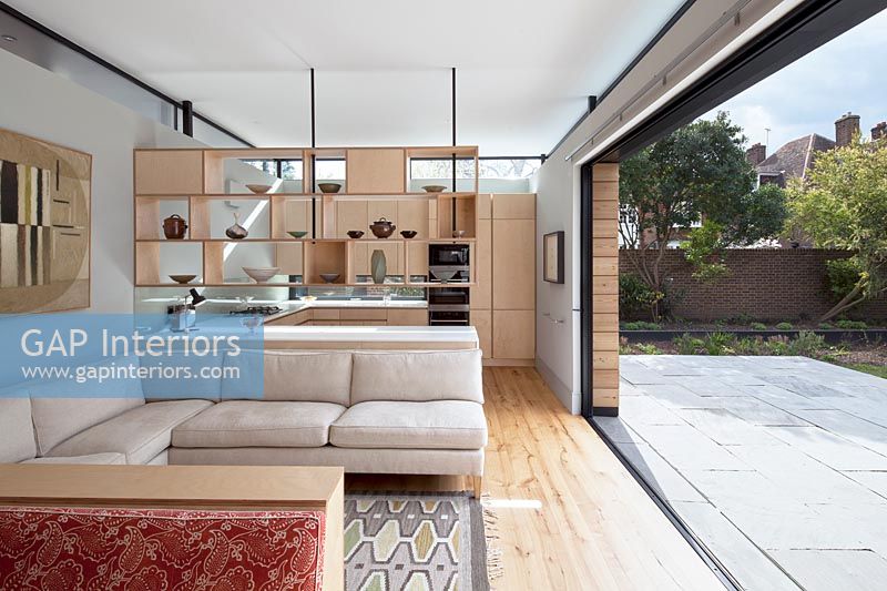 Contemporary open plan living space with open patio doors 