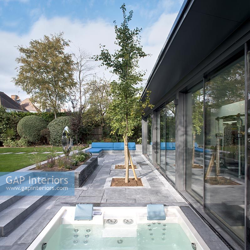 Jacuzzi and seating area on modern terrace 